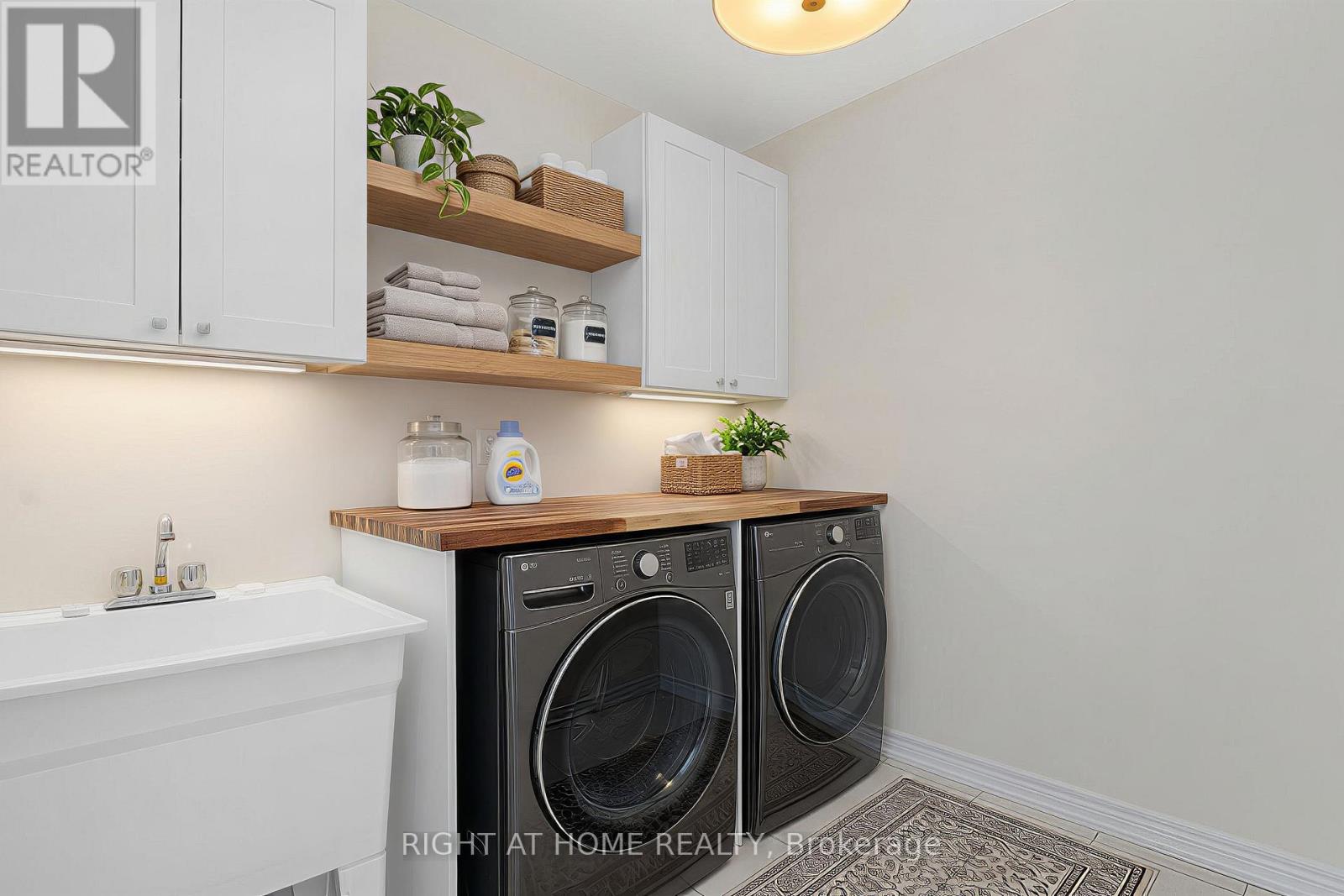 Laundry room — washer and dryer, cabinetry