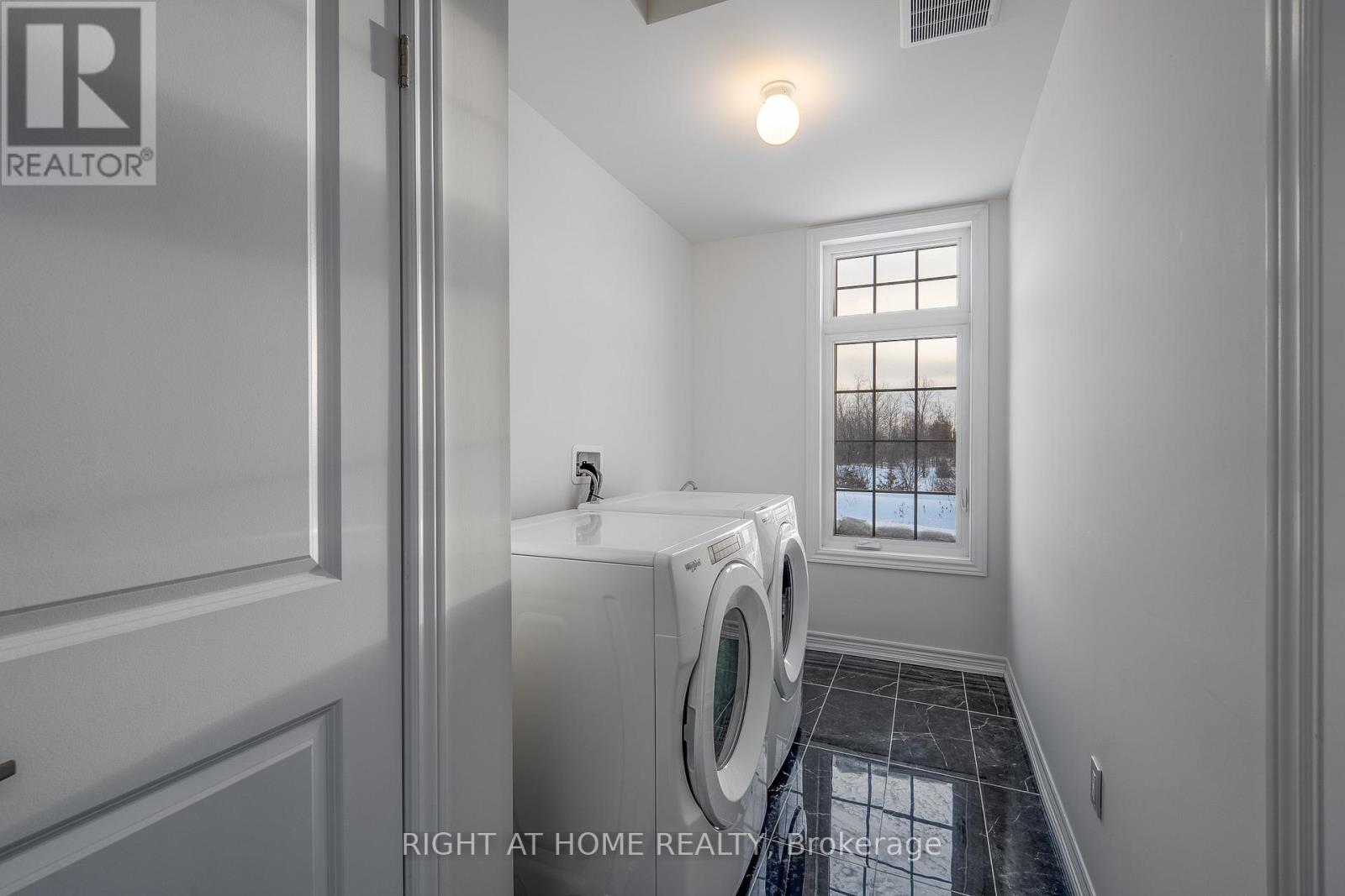 Laundry room — washer and dryer, cabinetry