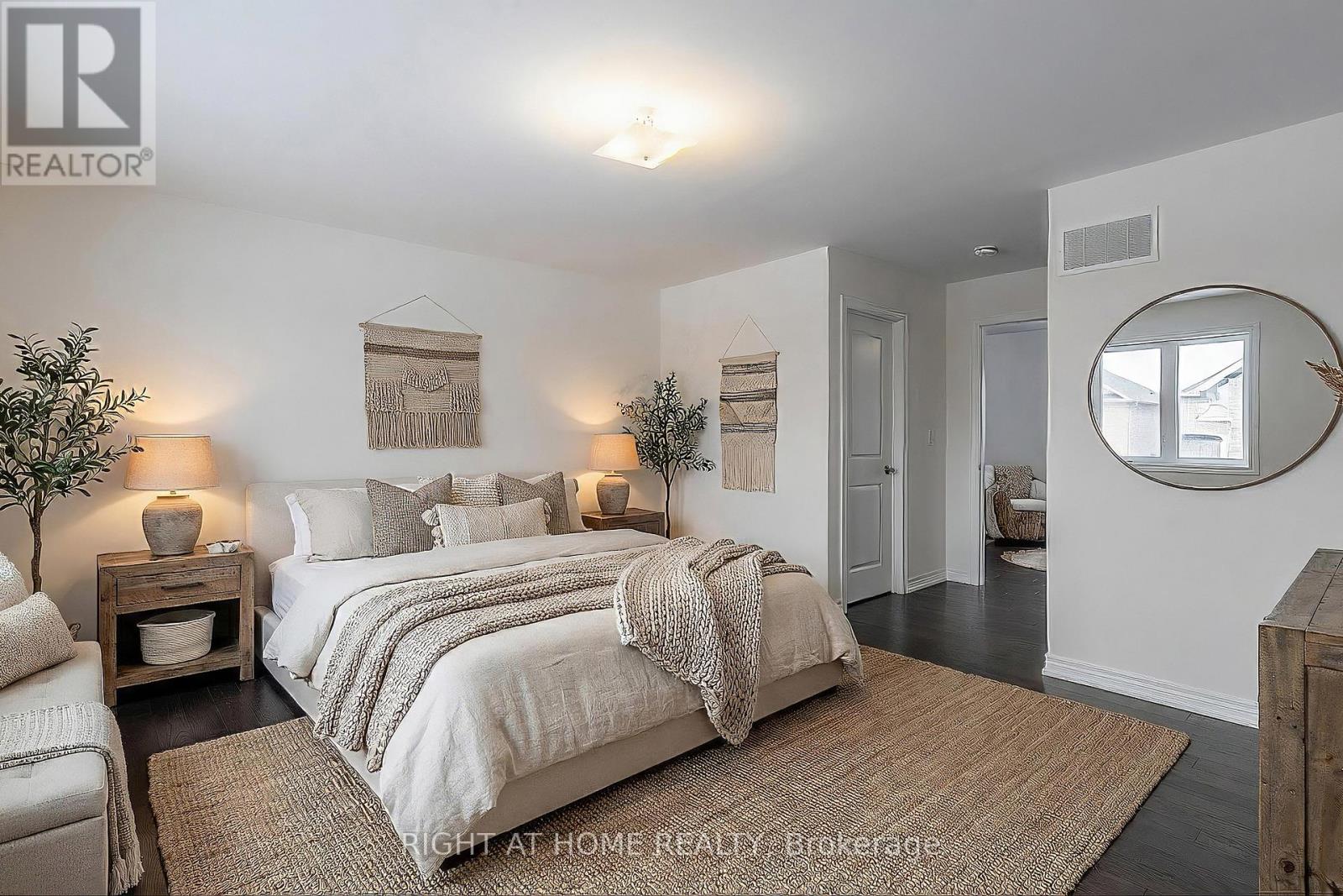 Primary bedroom — spacious layout, hardwood