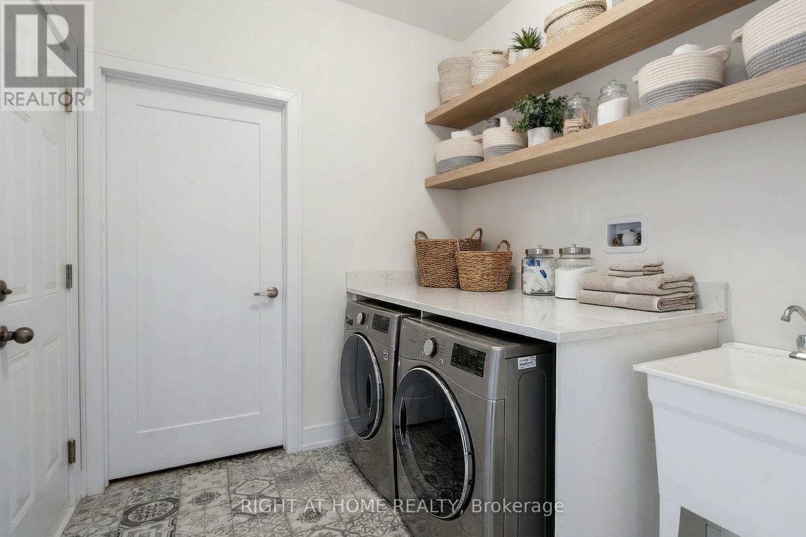 Laundry room — washer and dryer, cabinetry