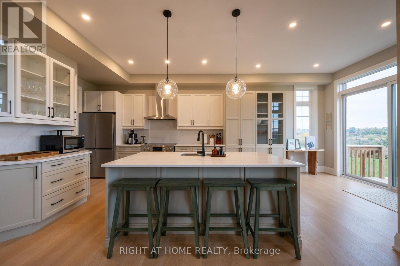 Kitchen — quartz island, pendant lights, stainless appliances