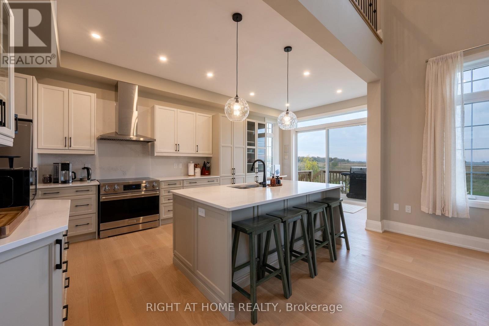 Kitchen — island with bar stools, sliding doors to deck