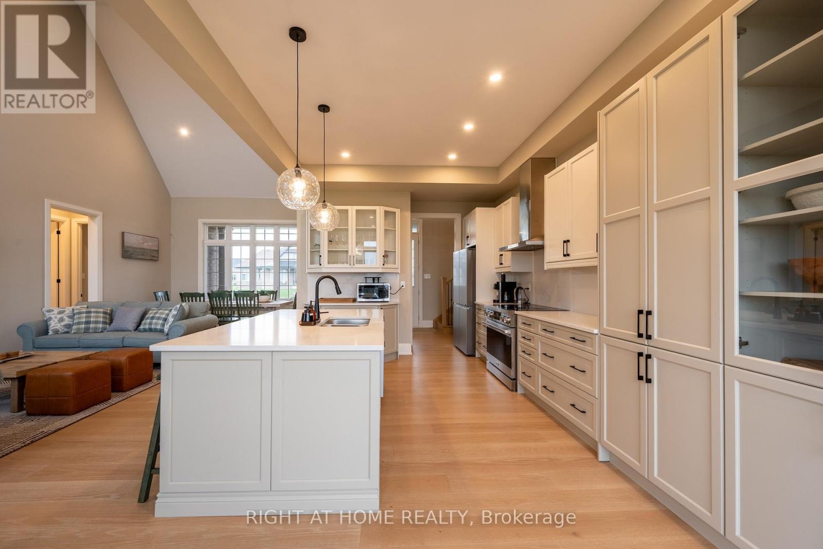 Kitchen — full island, tall cabinetry, open to living