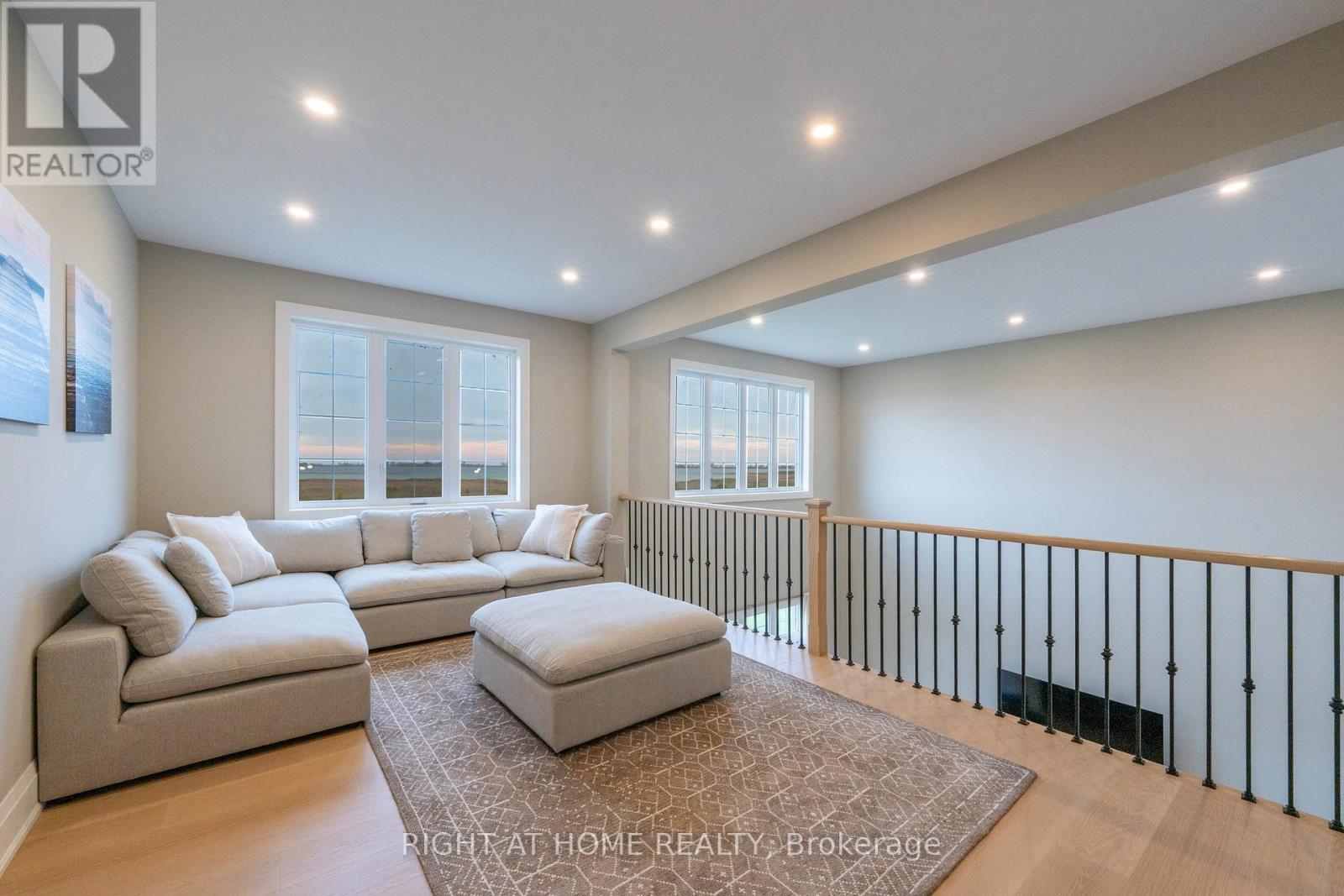 Upper level loft — sectional sofa, iron and oak railing