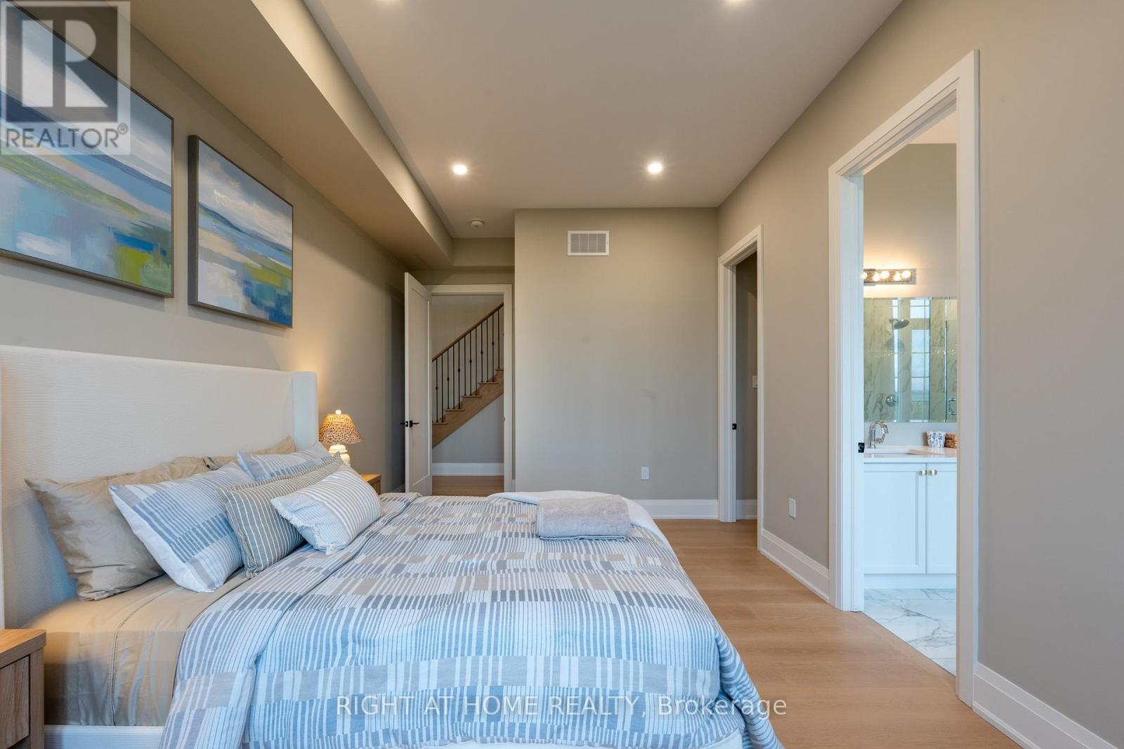 Primary bedroom — ensuite doorway, tray ceiling