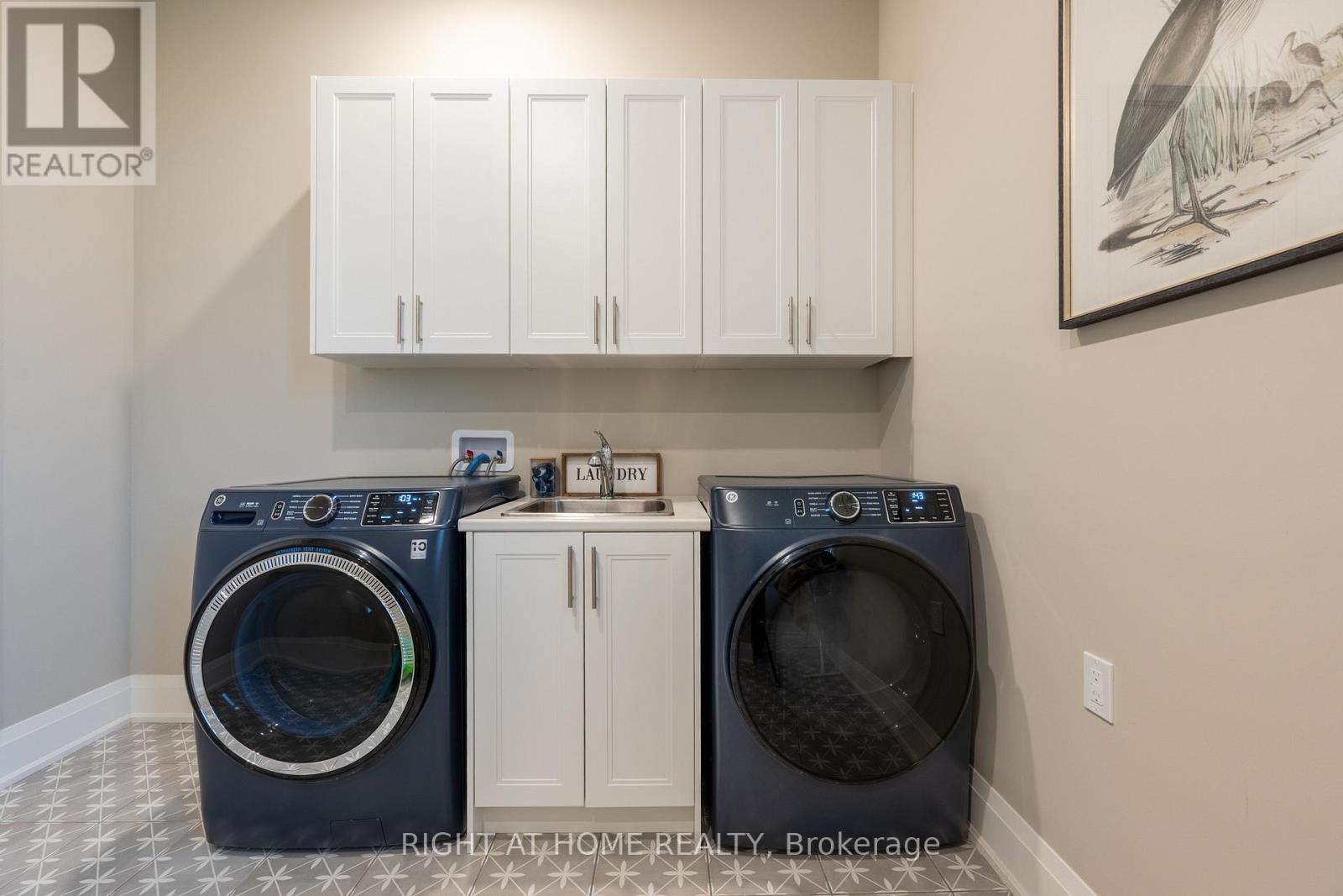 Laundry room — front-load washer and dryer, utility sink