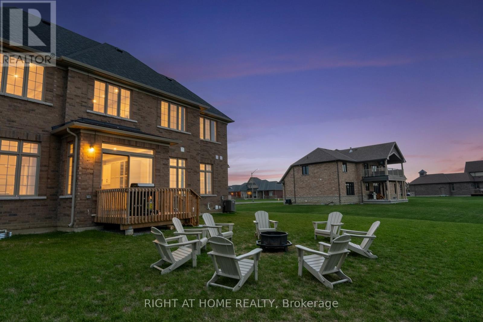 Backyard at twilight — fire pit, Adirondack chairs