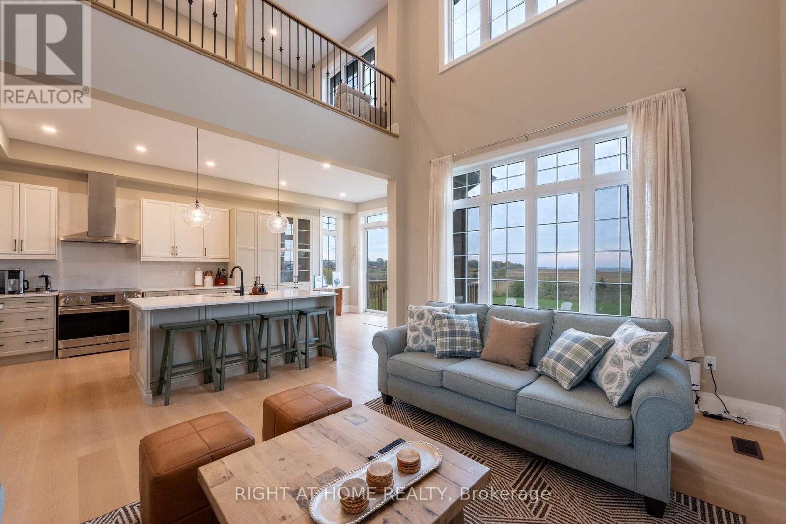 Great room — double-height ceilings, loft, kitchen island
