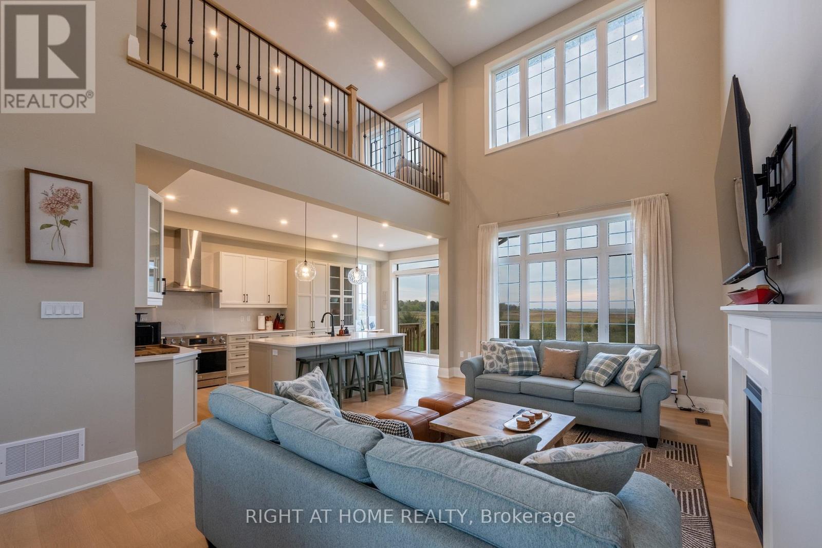 Great room — hardwood floors, expansive windows
