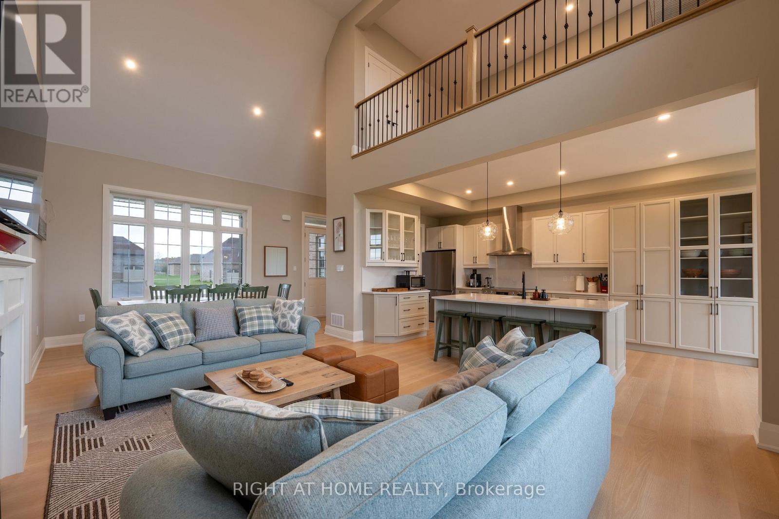 Great room — loft balcony, kitchen, pendant lights
