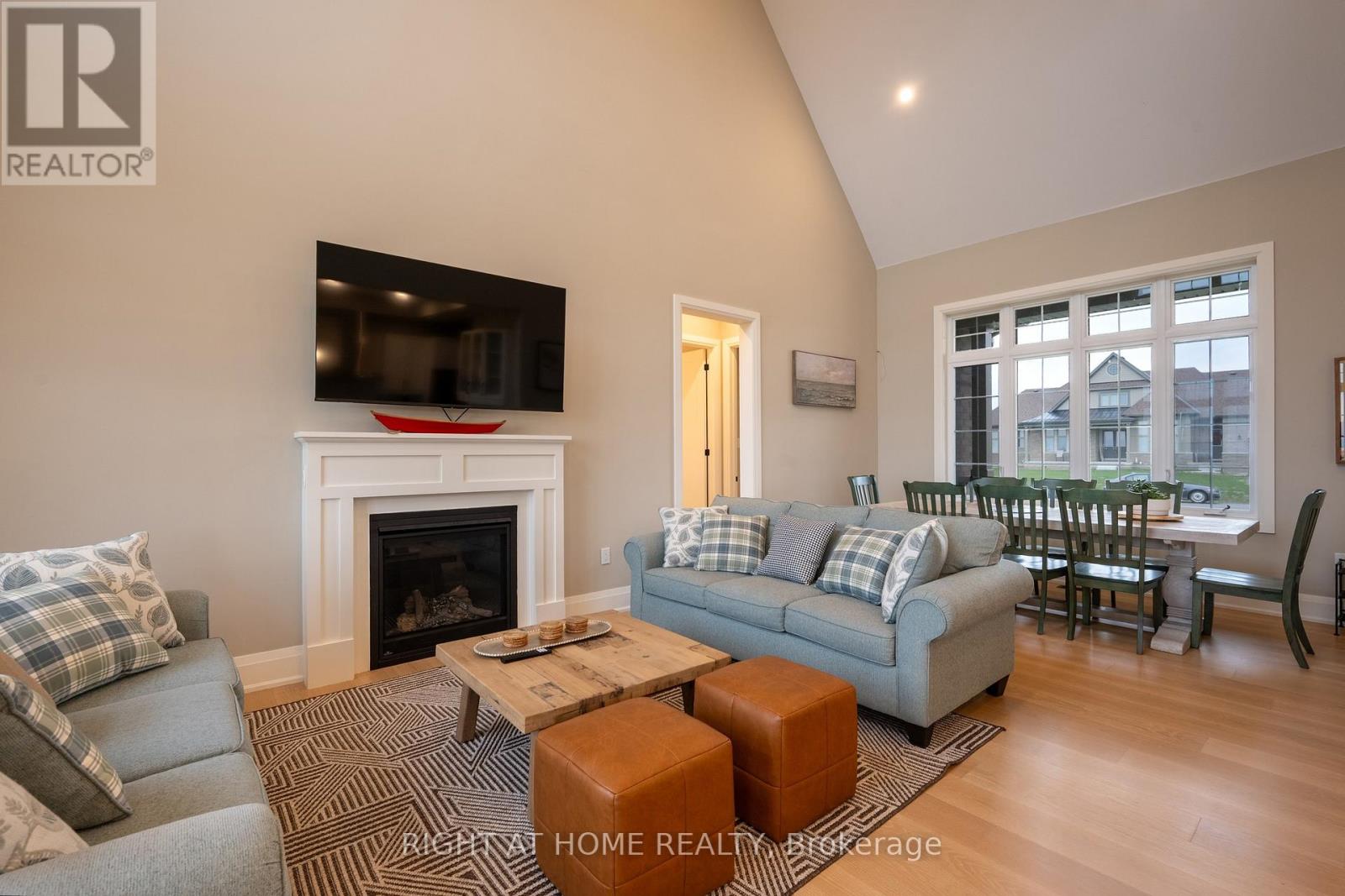 Great room — fireplace and large windows
