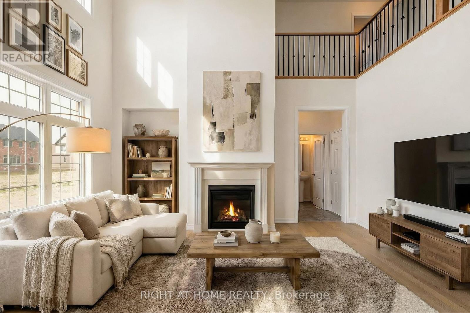 Great room — 21-foot ceiling, fireplace, loft railing