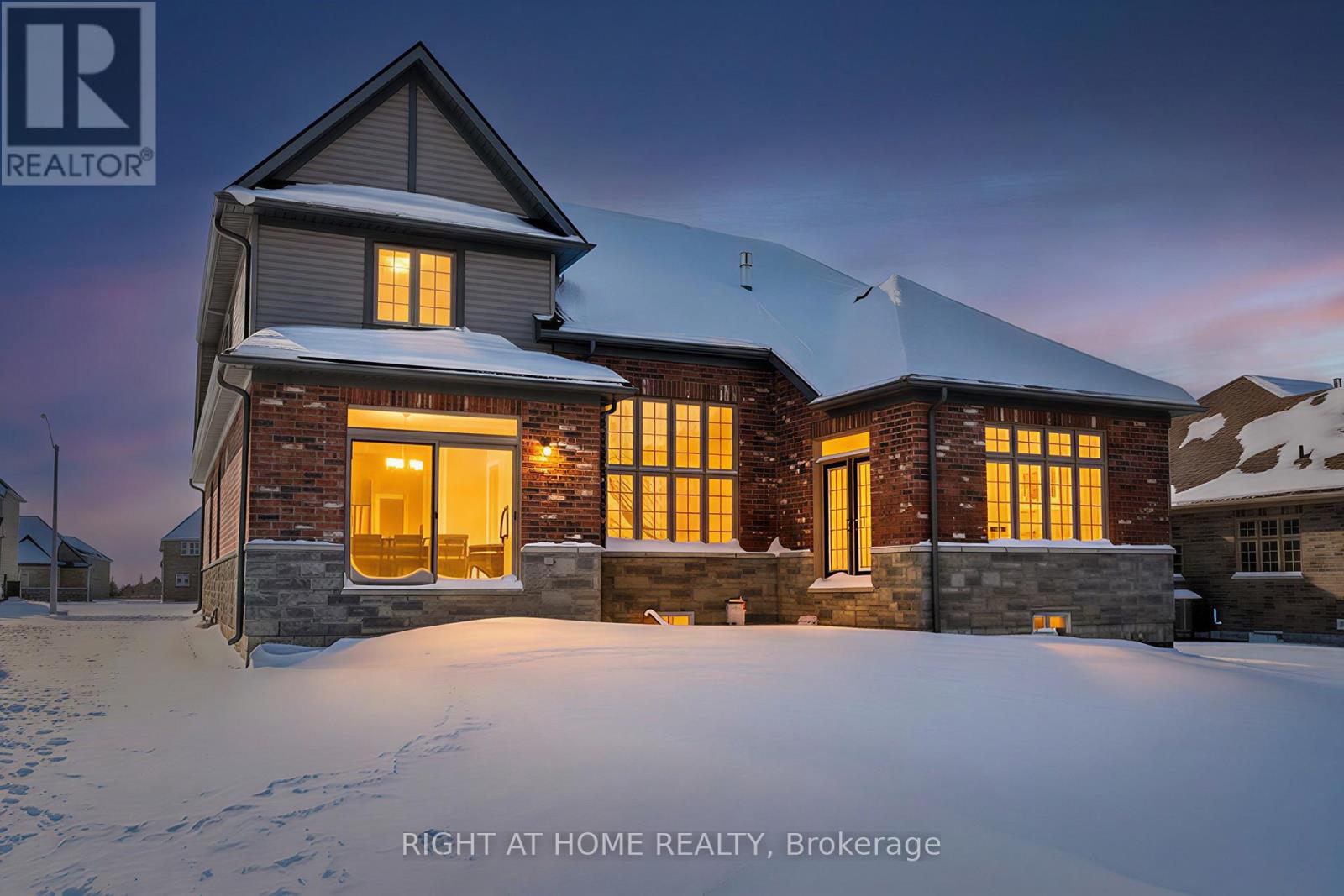 Rear exterior at twilight — large windows, snowy backyard