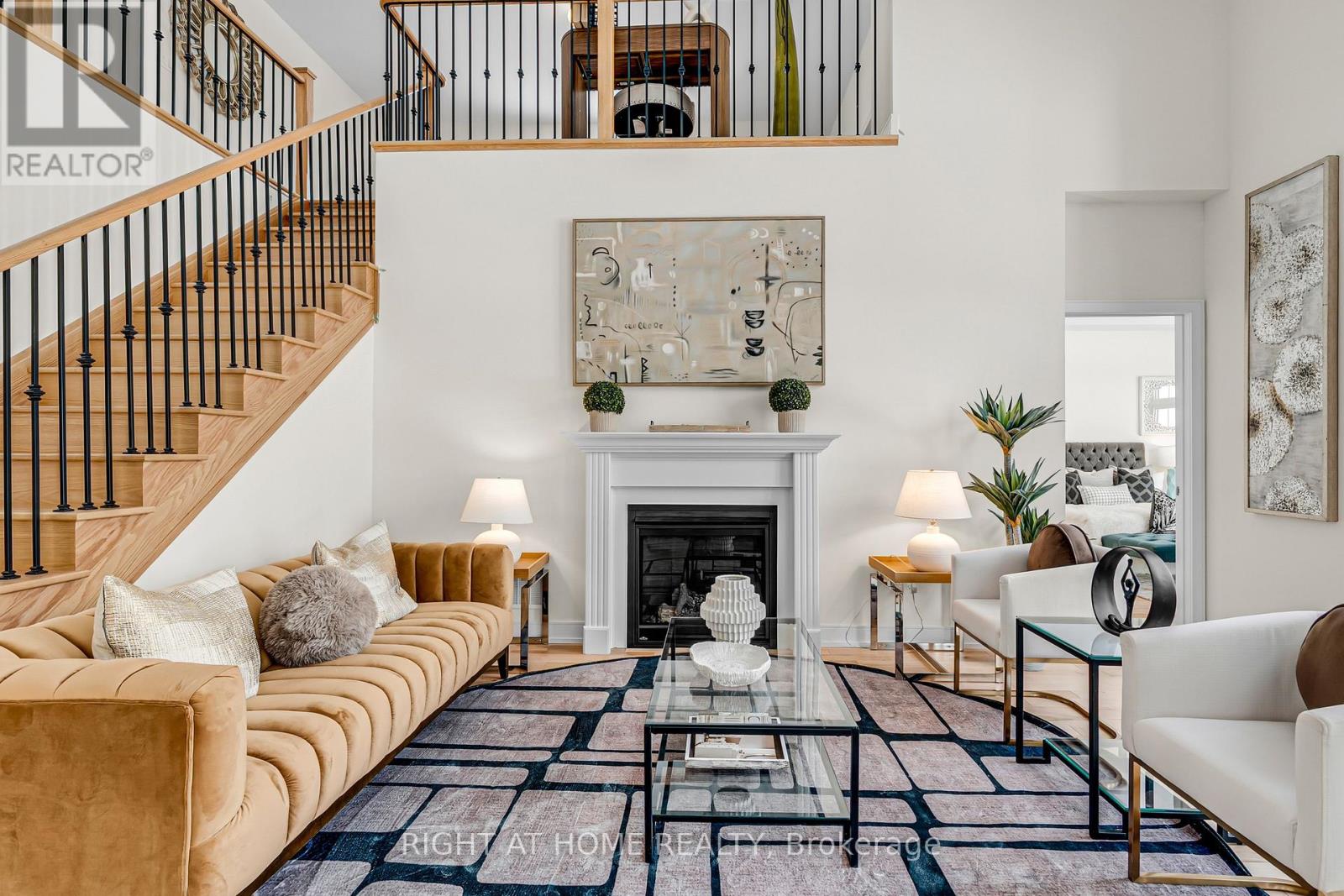 Great room — staircase and fireplace view